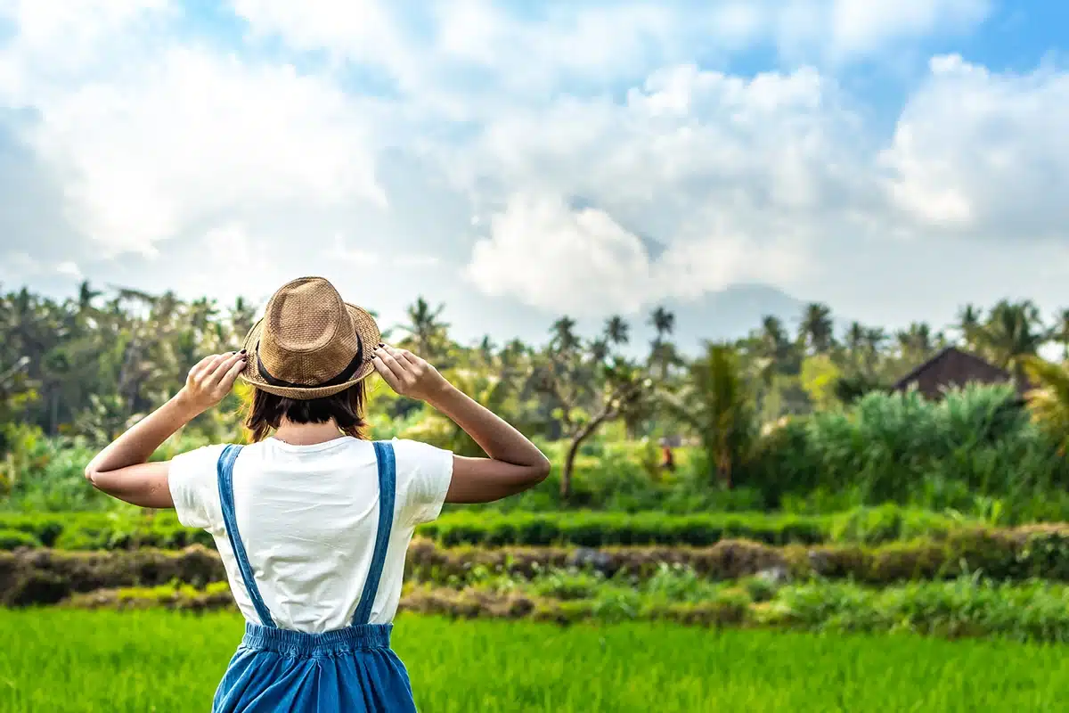 Closeup portrait of happy woman tourist with straw hat